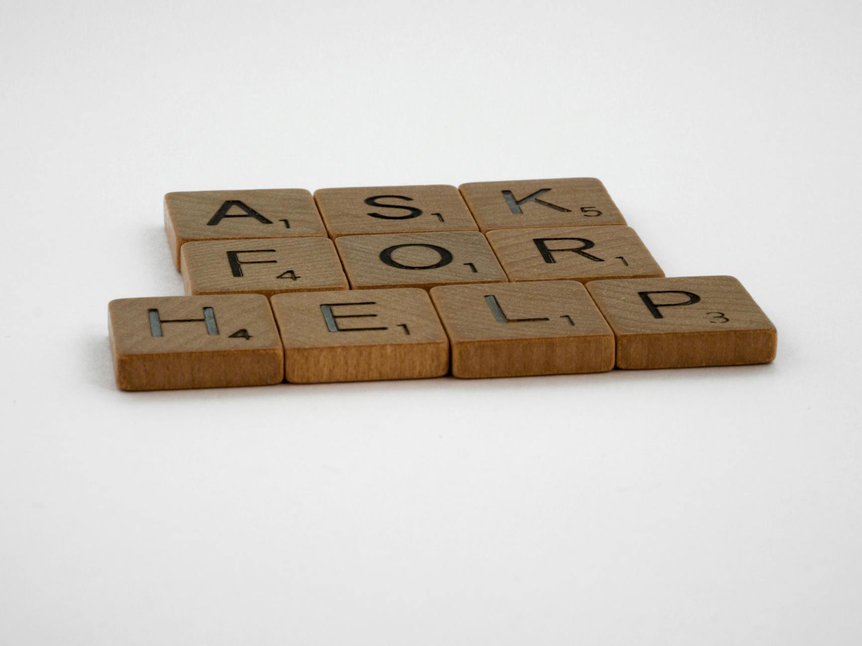 brown wooden scrabble tiles on white surface